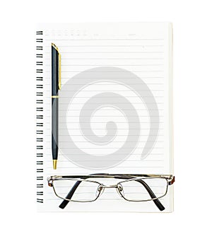Eyeglasses and notepad on wood deck