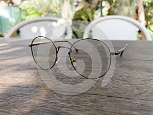 Eyeglasses on old wooden table