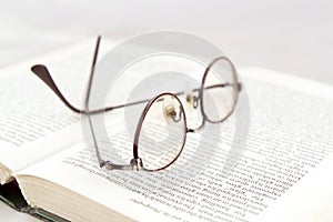 Eyeglasses on open book