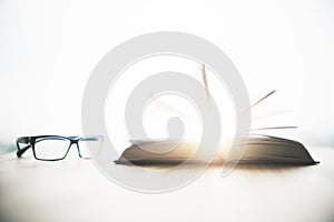 Eyeglasses and open book