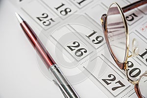 Eyeglasses And Pen On The Calendar