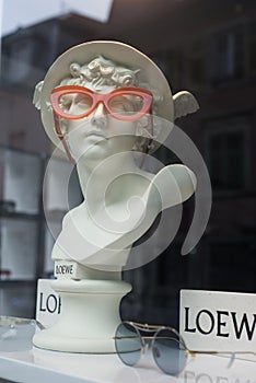 Eyeglasses presentaion on statue by Loewe in optician  store showroom