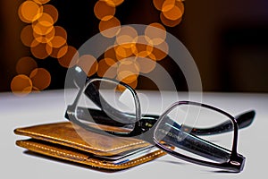Eyeglasses and Wallet with a Soft Light Background photo