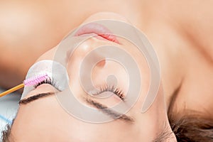Eyelash brush lengthening woman`s lashes photo