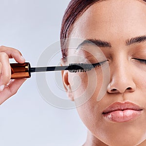 Eyelash extension, beauty or girl with mascara makeup, cosmetics or product brush for grooming in studio. Face or
