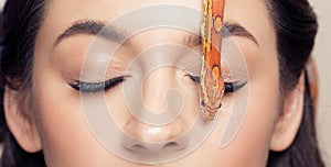 Eyelash extension concept banner. Face of young woman with snake, beautiful makeup