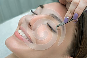 Eyelash Extension Procedure.  Beauty Model with  Perfect Fresh Skin and Long Eyelashes. Skincare, Spa and Wellness.