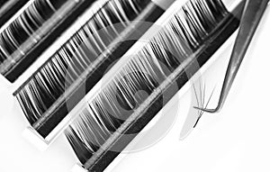 Eyelash extension procedure. Lashes tweezers set macro photo, isolated white background