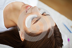 Eyelash Extension Procedure, Professional stylist lengthening female lashes.