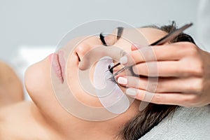 Eyelash extension procedure with tweezers