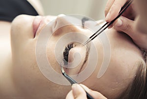 Eyelash Extension Procedure.  Woman Eye with Long Eyelashes