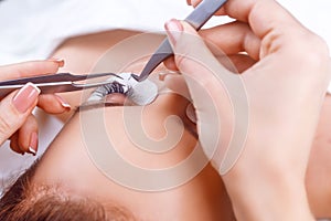 Eyelash Extension Procedure. Woman Eye with Long Eyelashes. Eyelashes with rhinestone. Lashes, close up, macro