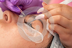 Eyelash extension procedure. Woman eye with long eyelashes. lashes, close up, macro, selective focus.