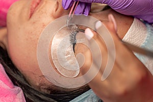 Eyelash extension procedure. Woman eye with long eyelashes. lashes, close up, macro, selective focus.