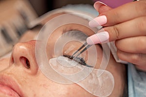 Eyelash extension procedure. Woman eye with long eyelashes. lashes, close up, macro, selective focus.