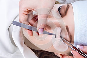 Eyelash Extension Procedure. Woman Eye with Long Eyelashes. Lashes, close up, selected focus.