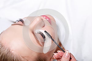 Eyelash Extension Procedure. Woman Eye with Long Eyelashes. Lashes, close up, selected focus.