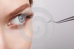 Eyelash Extension Procedure. Woman Eye with Long Eyelashes. Lashes, close up, selected focus.