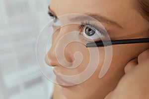 Eyelash Extension Procedure. Woman Eye with Long Eyelashes. Lashes. Close up, selected focus.