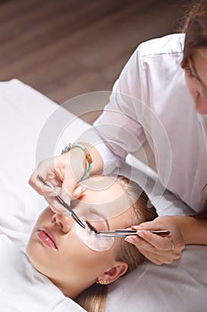 Eyelash Extension Procedure. Woman Eye with Long Eyelashes. Lashes, close up, selected focus.