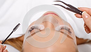 Eyelash Extension Procedure. Woman Eye with Long Eyelashes. Lashes, close up, selected focus.