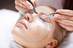 Eyelash Extension Procedure. Woman Eye with Long Eyelashes. Lashes, close up, selected focus.