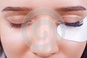 Eyelash Extension Procedure. Woman Eye with Long Eyelashes. Lashes, close up, selected focus.