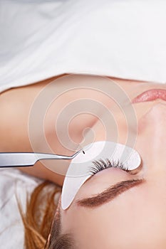 Eyelash Extension Procedure. Woman Eye with Long Eyelashes. Lashes, close up, selected focus.