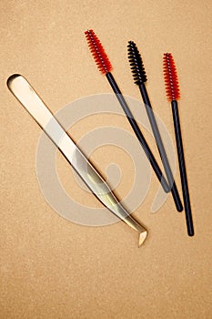 Eyelash extension tools on a gold background