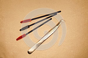 Eyelash extension tools on a gold background