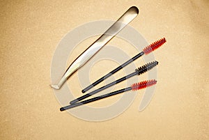 Eyelash extension tools on a gold background