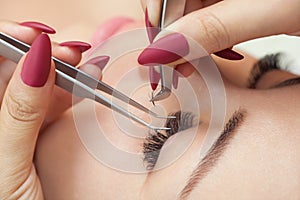 Eyelash removal procedure close up. Beautiful Woman with long lashes