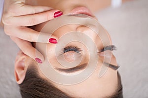 Eyelashes extensions. Fake Eyelashes. Eyelash Extension Procedure. Professional stylist lengthening female lashes