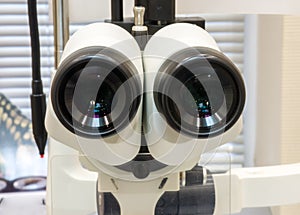 Eyepieces of ophthalmologic device slit lamp closeup in Office of ophthalmologist. Photos of diagnostic procedure of eye disease