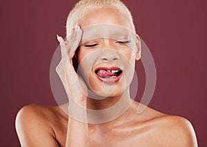 Eyes closed, tongue out and face skincare of woman in studio isolated on a red background. Dermatology, makeup cosmetics