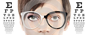 Eyes and eyeglasses close up on visual test chart, eyesight and