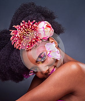 Eyes, flowers and lashes with portrait of black woman in studio on dark background for natural cosmetics. Afro, beauty