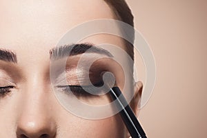 Make-up artist apply eyeshadow with brush, beauty