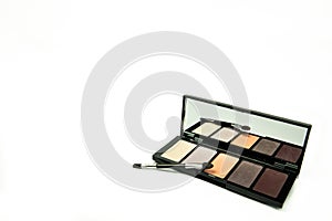 Eyeshadow and brush with mirror on a white background