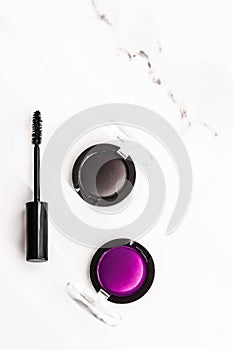 Eyeshadows, black liner and mascara on marble background, eye shadows cosmetics as glamour make-up products for luxury beauty