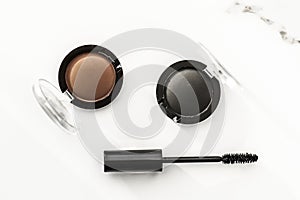 Eyeshadows, black liner and mascara on marble background, eye shadows cosmetics as glamour make-up products for luxury beauty