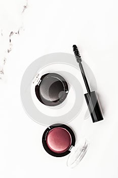 Eyeshadows, black liner and mascara on marble background, eye shadows cosmetics as glamour make-up products for luxury beauty