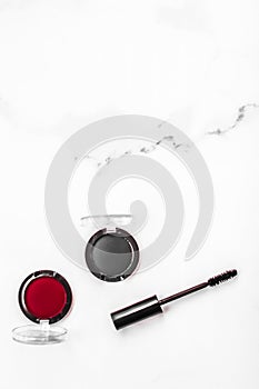 Eyeshadows, black liner and mascara on marble background, eye shadows cosmetics as glamour make-up products for luxury beauty