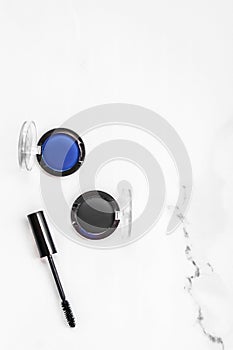 Eyeshadows, black liner and mascara on marble background, eye shadows cosmetics as glamour make-up products for luxury beauty