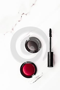 Eyeshadows, black liner and mascara on marble background, eye shadows cosmetics as glamour make-up products for luxury beauty