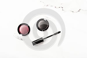 Eyeshadows, black liner and mascara on marble background, eye shadows cosmetics as glamour make-up products for luxury beauty