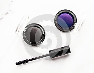 Eyeshadows, black liner and mascara on marble background, eye shadows cosmetics as glamour make-up products for luxury beauty