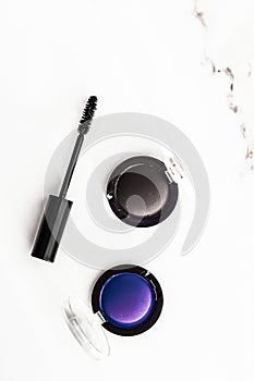 Eyeshadows, black liner and mascara on marble background, eye shadows cosmetics as glamour make-up products for luxury beauty