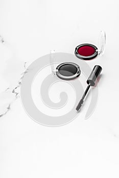 Eyeshadows, black liner and mascara on marble background, eye shadows cosmetics as glamour make-up products for luxury beauty