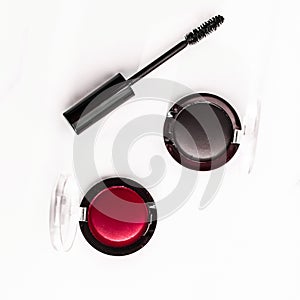 Eyeshadows, black liner and mascara on marble background, eye shadows cosmetics as glamour make-up products for luxury beauty